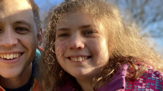 A father and daughter smile in a selfie.