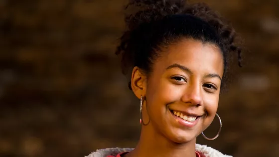 Photograph of young woman smiling at the camera  