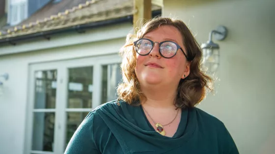 Young woman gazes up in to the sky