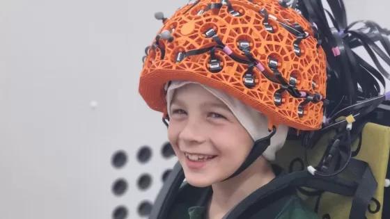 Young boy wears the OPM MEG for epilepsy diagnosis