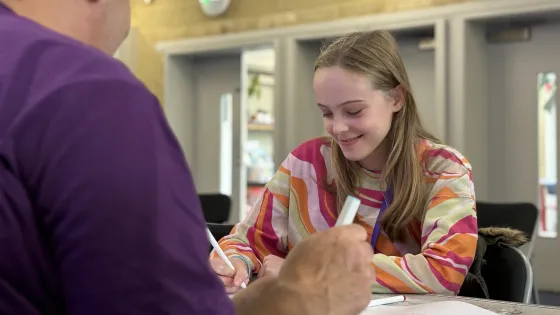 Young girl working at desk with Youth Support Coordinator