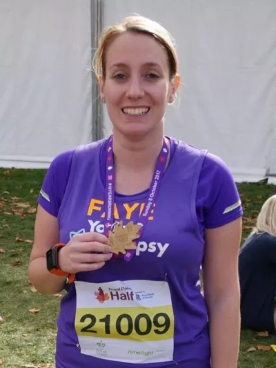 Faye and her medal for a half marathon