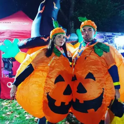 A couple in inflatable pumpkin costumes