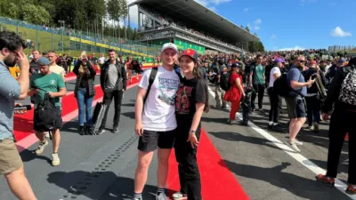 Young girl poses on a race track with her partner