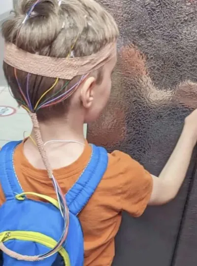 Young boy with electrodes on his head