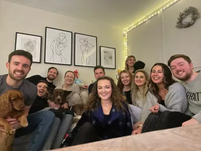 A large group of young adults gather at a friendly meeting.