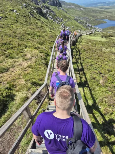 Walkers in a line going down steps