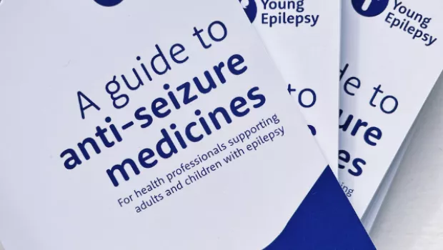 Three 'guide to anti-seizure medicines' booklets by Young Epilepsy are stacked on top of each other.