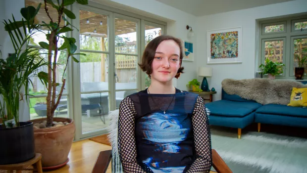 teenage girl sat smiling