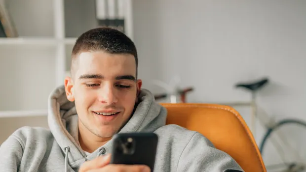Young boy smiling on a video call on his mobile phone