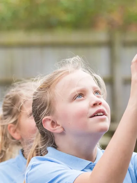 Photo of school student playing netball with classmates