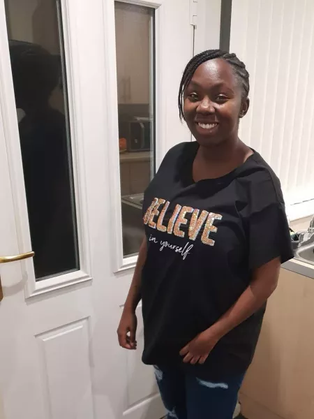 Lauren, a young woman in a 'Believe' t-shirt, poses for a photograph.