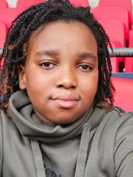 Teenage boy sat in a sports stadium