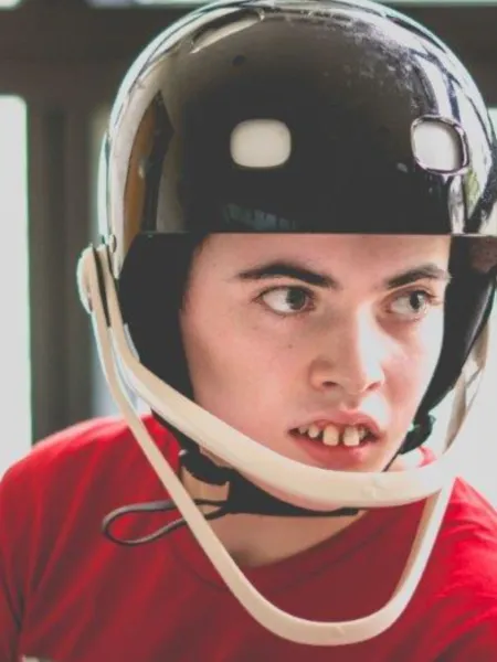 A young boy wearing a protective helmet