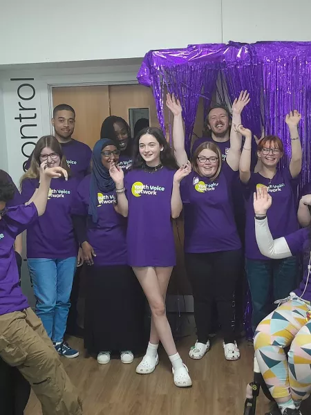 Members of Youth Voice all cheer while wearing purple Young Epilepsy t-shirts.