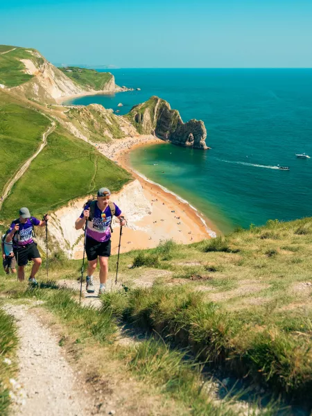 Walkers on a hill in front of Durdle Door